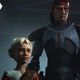 Omega (left) stands next to her brother Hunter (right), cradling his Clone Trooper helmet under his arm.